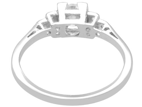 fig 3. An Art Deco white gold and platinum ring featuring a central round diamond with stepped accent diamond shoulders.