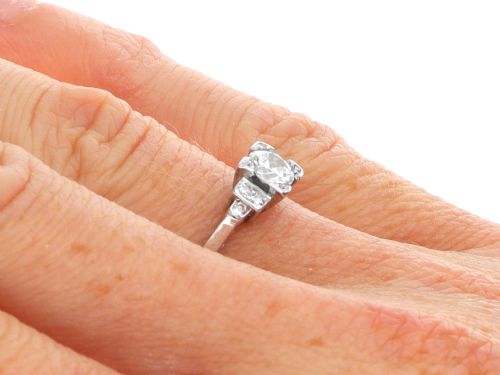 fig 6. An Art Deco white gold and platinum ring featuring a central round diamond with stepped accent diamond shoulders.