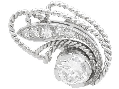 fig 3. A pair of Art Deco platinum earrings featuring round diamonds set within a textured rope-twist swirl design.
