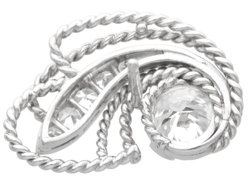 fig 4. A pair of Art Deco platinum earrings featuring round diamonds set within a textured rope-twist swirl design.