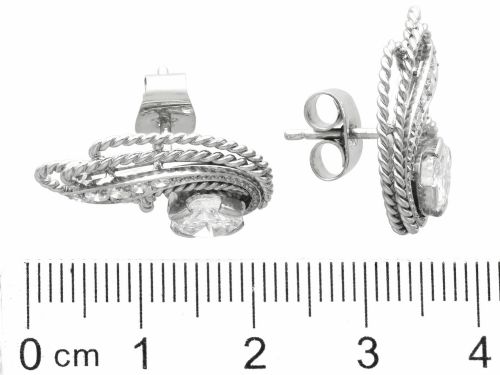 fig 6. A pair of Art Deco platinum earrings featuring round diamonds set within a textured rope-twist swirl design.