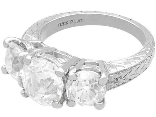fig 6. An antique platinum trilogy ring set with three cushion cut diamonds and decorated with hand-engraved shoulders.