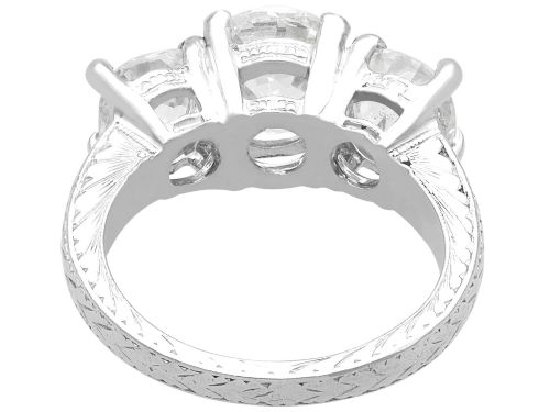 fig 7. An antique platinum trilogy ring set with three cushion cut diamonds and decorated with hand-engraved shoulders.