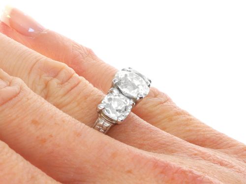 fig 10. An antique platinum trilogy ring set with three cushion cut diamonds and decorated with hand-engraved shoulders.