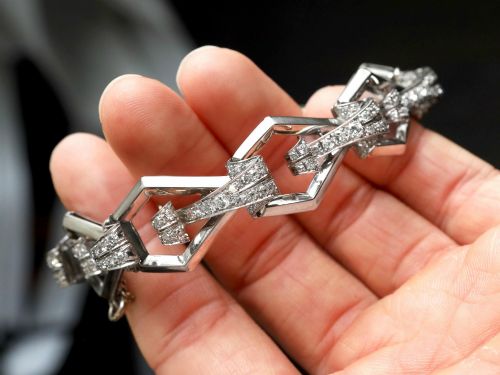 fig 4. An Art Deco 18ct white gold link bracelet set with diamonds arranged in geometric openwork motifs.
