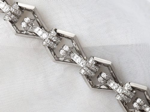 fig 6. An Art Deco 18ct white gold link bracelet set with diamonds arranged in geometric openwork motifs.