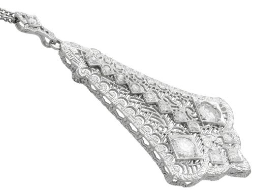 fig 7. An Art Deco 14ct white gold pendant featuring geometric pierced filigree lattice work set with multiple diamonds suspended from a chain.