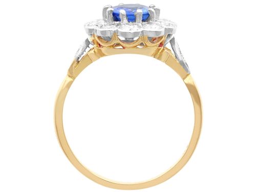 fig 6. An 18ct yellow gold cluster ring featuring an oval blue sapphire surrounded by a halo of round diamonds set in platinum.
