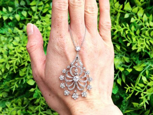 fig 1. An antique Edwardian openwork platinum pendant set with diamonds in a teardrop silhouette with floral motifs, suspended from a fine chain.