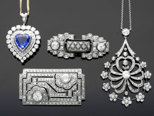 fig 2. An antique Edwardian openwork platinum pendant set with diamonds in a teardrop silhouette with floral motifs, suspended from a fine chain.