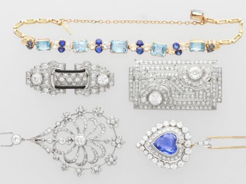fig 3. An antique Edwardian openwork platinum pendant set with diamonds in a teardrop silhouette with floral motifs, suspended from a fine chain.