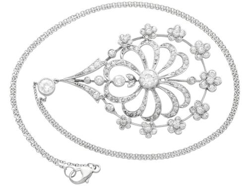 fig 4. An antique Edwardian openwork platinum pendant set with diamonds in a teardrop silhouette with floral motifs, suspended from a fine chain.
