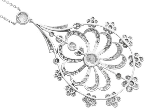 fig 6. An antique Edwardian openwork platinum pendant set with diamonds in a teardrop silhouette with floral motifs, suspended from a fine chain.