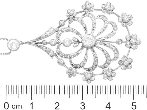 fig 7. An antique Edwardian openwork platinum pendant set with diamonds in a teardrop silhouette with floral motifs, suspended from a fine chain.
