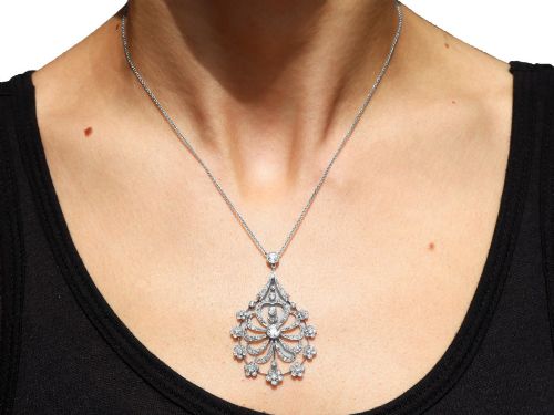 fig 8. An antique Edwardian openwork platinum pendant set with diamonds in a teardrop silhouette with floral motifs, suspended from a fine chain.