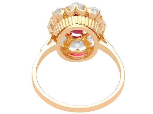 fig 7. An 18ct rose gold cluster ring featuring a central oval red ruby surrounded by eight old cut diamonds set in individual claw settings.