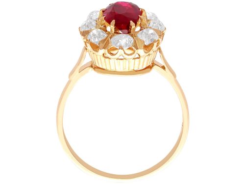fig 8. An 18ct rose gold cluster ring featuring a central oval red ruby surrounded by eight old cut diamonds set in individual claw settings.