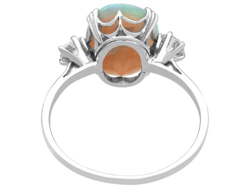 fig 8. An antique platinum trilogy ring featuring a central oval cabochon opal flanked by two round cut diamonds.