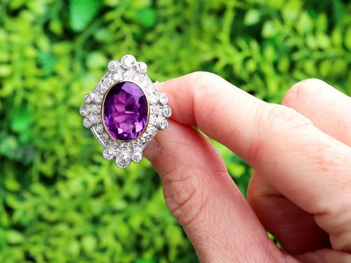 fig 1. An Art Deco ring featuring a central oval purple amethyst set in yellow gold, framed by a millegrain diamond halo.