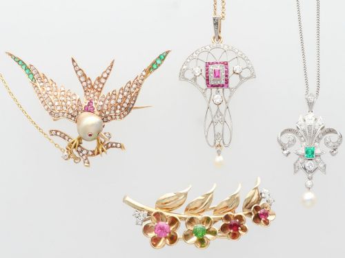 fig 6. An Edwardian openwork yellow gold pendant set with a central square-cut ruby surrounded by small rubies, diamonds, and a suspended natural pearl drop.