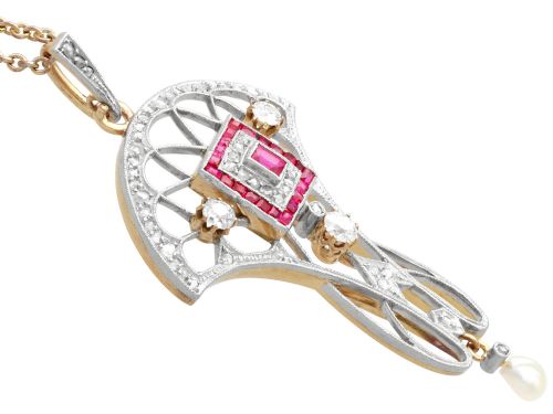 fig 8. An Edwardian openwork yellow gold pendant set with a central square-cut ruby surrounded by small rubies, diamonds, and a suspended natural pearl drop.