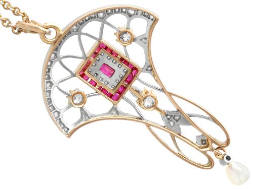 fig 9. An Edwardian openwork yellow gold pendant set with a central square-cut ruby surrounded by small rubies, diamonds, and a suspended natural pearl drop.
