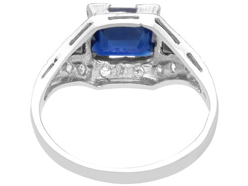 fig 5. An Art Deco platinum ring featuring a central rectangular step-cut blue sapphire flanked by triangular sapphires and diamond-set shoulder details.