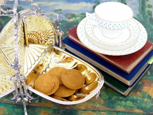 fig 6. An antique Victorian sterling silver folding biscuit box featuring shell-form compartments, an ornate looped handle, and an engraved 1897 monogram.
