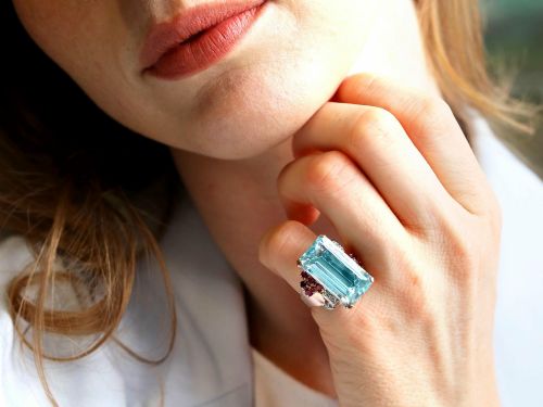 fig 3. A 1940s Retro rose gold cocktail ring set with a large emerald-cut aquamarine flanked by ruby clusters and diamond accents.