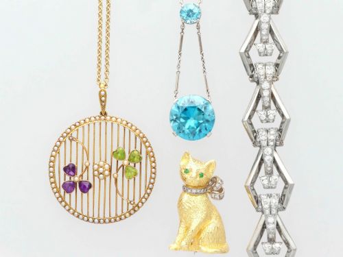 fig 5. An Art Deco 18ct white gold drop pendant set with two round brilliant-cut bright blue zircon gemstones suspended on delicate bar links.