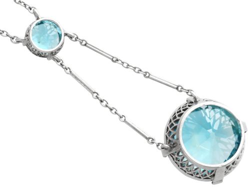 fig 8. An Art Deco 18ct white gold drop pendant set with two round brilliant-cut bright blue zircon gemstones suspended on delicate bar links.