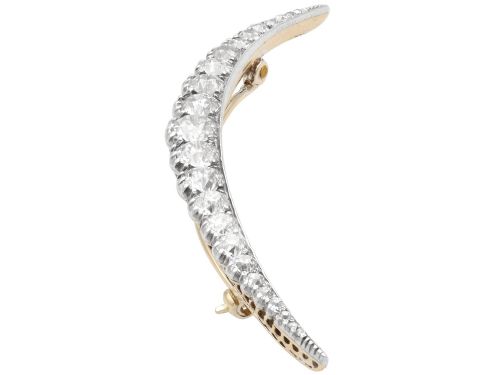 fig 7. An antique crescent-shaped brooch set with a row of graduated diamonds mounted in gold and silver.