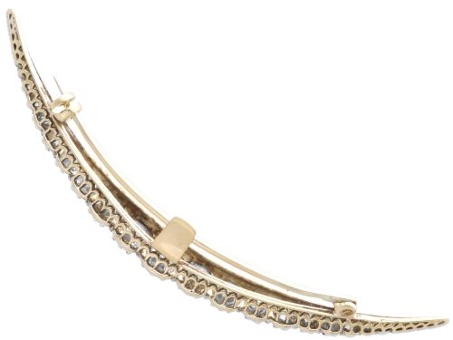 fig 8. An antique crescent-shaped brooch set with a row of graduated diamonds mounted in gold and silver.