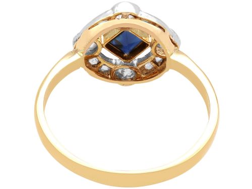 fig 5. An 18ct yellow gold ring featuring a central square blue sapphire surrounded by an openwork diamond-set frame.