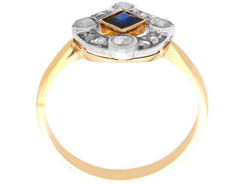 fig 6. An 18ct yellow gold ring featuring a central square blue sapphire surrounded by an openwork diamond-set frame.