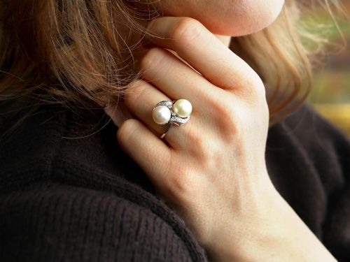 fig 3. A circa 1950 white gold crossover cocktail ring featuring two cultured pearls flanked by diamond-accented bypass shoulders.