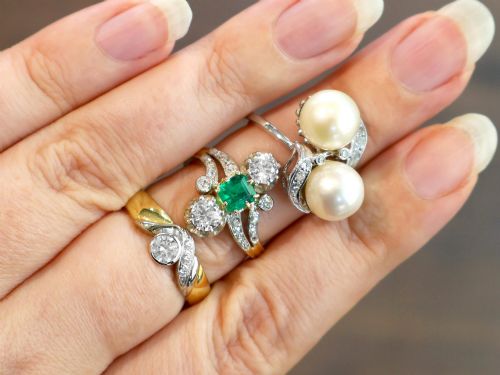 fig 4. A circa 1950 white gold crossover cocktail ring featuring two cultured pearls flanked by diamond-accented bypass shoulders.