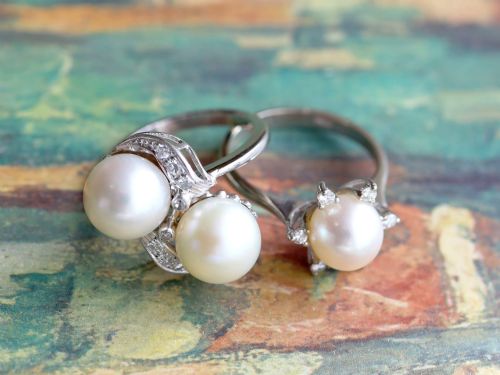 fig 5. A circa 1950 white gold crossover cocktail ring featuring two cultured pearls flanked by diamond-accented bypass shoulders.