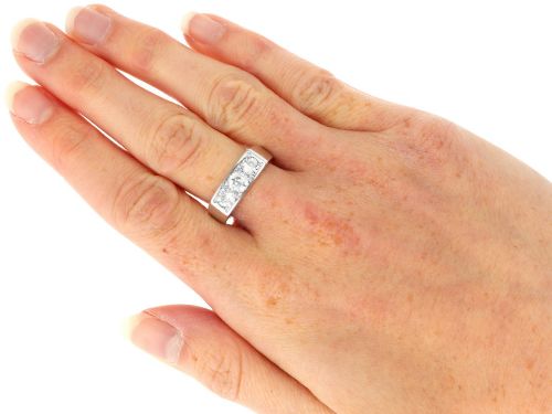 fig 7. An 18ct white gold Art Deco trilogy ring featuring three round diamonds set horizontally across a wide band.