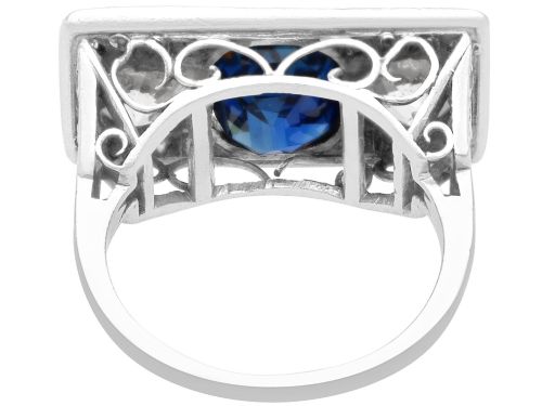 fig 7. An Art Deco platinum plaque ring set with a central blue sapphire flanked by two large diamonds and surrounded by smaller pave-set diamonds.