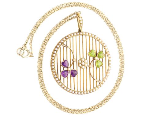 fig 7. A circular 18ct yellow gold openwork pendant set with seed pearls along the outer rim, containing peridot and amethyst trefoil motifs and a central seed pearl cluster.