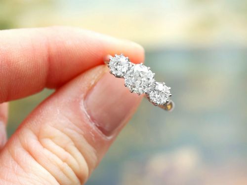 fig 2. An Art Deco platinum ring set with three claw-set round diamonds positioned horizontally along the band.