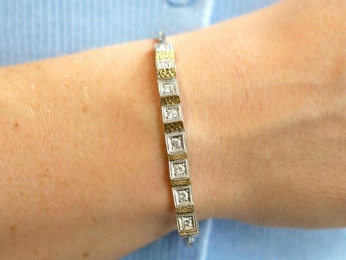 fig 4. An Art Deco two-tone 18ct gold and white metal link bracelet featuring square diamond-set panels alternating with textured gold links.
