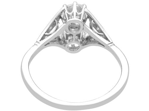 fig 7. An Art Deco platinum two stone ring featuring round diamonds arranged vertically within a crossover frame with diamond-set shoulders.