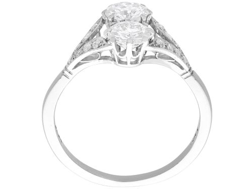 fig 8. An Art Deco platinum two stone ring featuring round diamonds arranged vertically within a crossover frame with diamond-set shoulders.