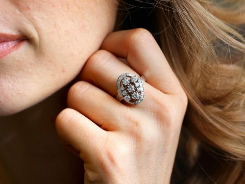 fig 2. A vintage 1950s 14ct white gold dress ring featuring a multi-diamond cluster and curved accent bands.