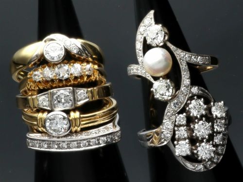 fig 4. A vintage 1950s 14ct white gold dress ring featuring a multi-diamond cluster and curved accent bands.