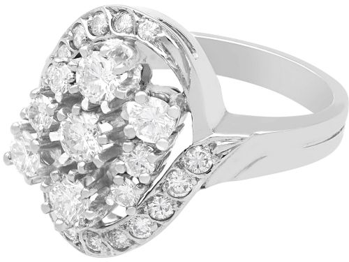 fig 5. A vintage 1950s 14ct white gold dress ring featuring a multi-diamond cluster and curved accent bands.