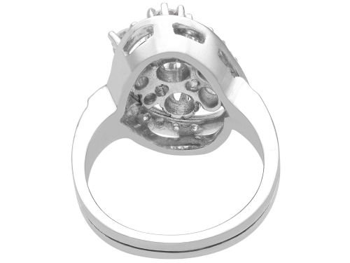 fig 6. A vintage 1950s 14ct white gold dress ring featuring a multi-diamond cluster and curved accent bands.