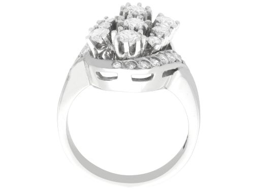 fig 7. A vintage 1950s 14ct white gold dress ring featuring a multi-diamond cluster and curved accent bands.